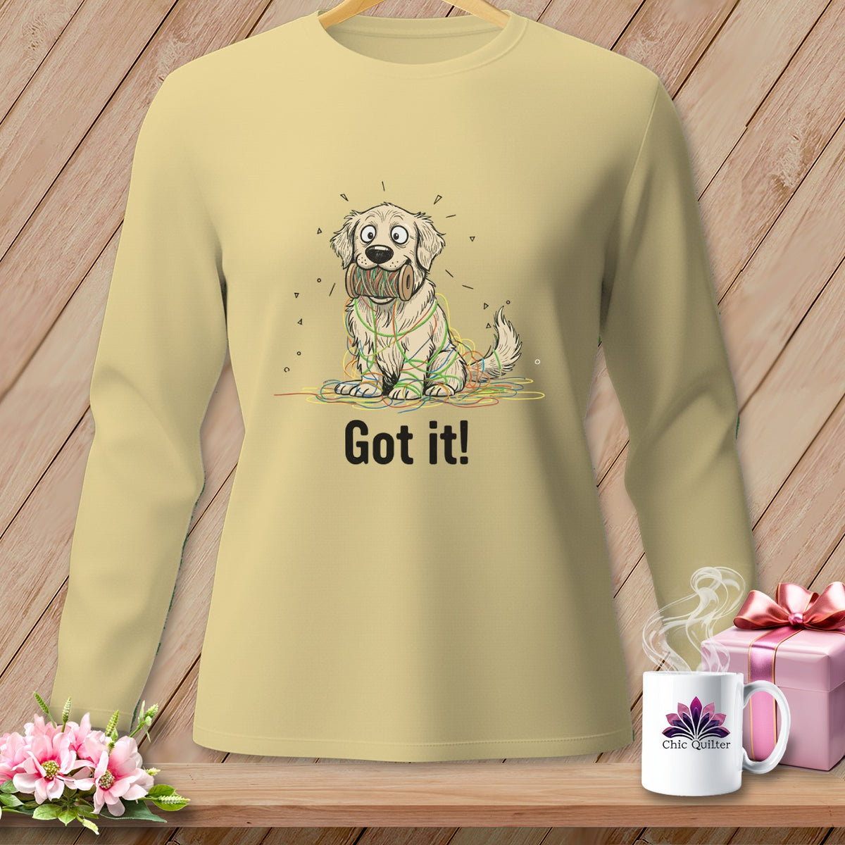 Golden retriever tangled in colorful yarn with text "Got it!".