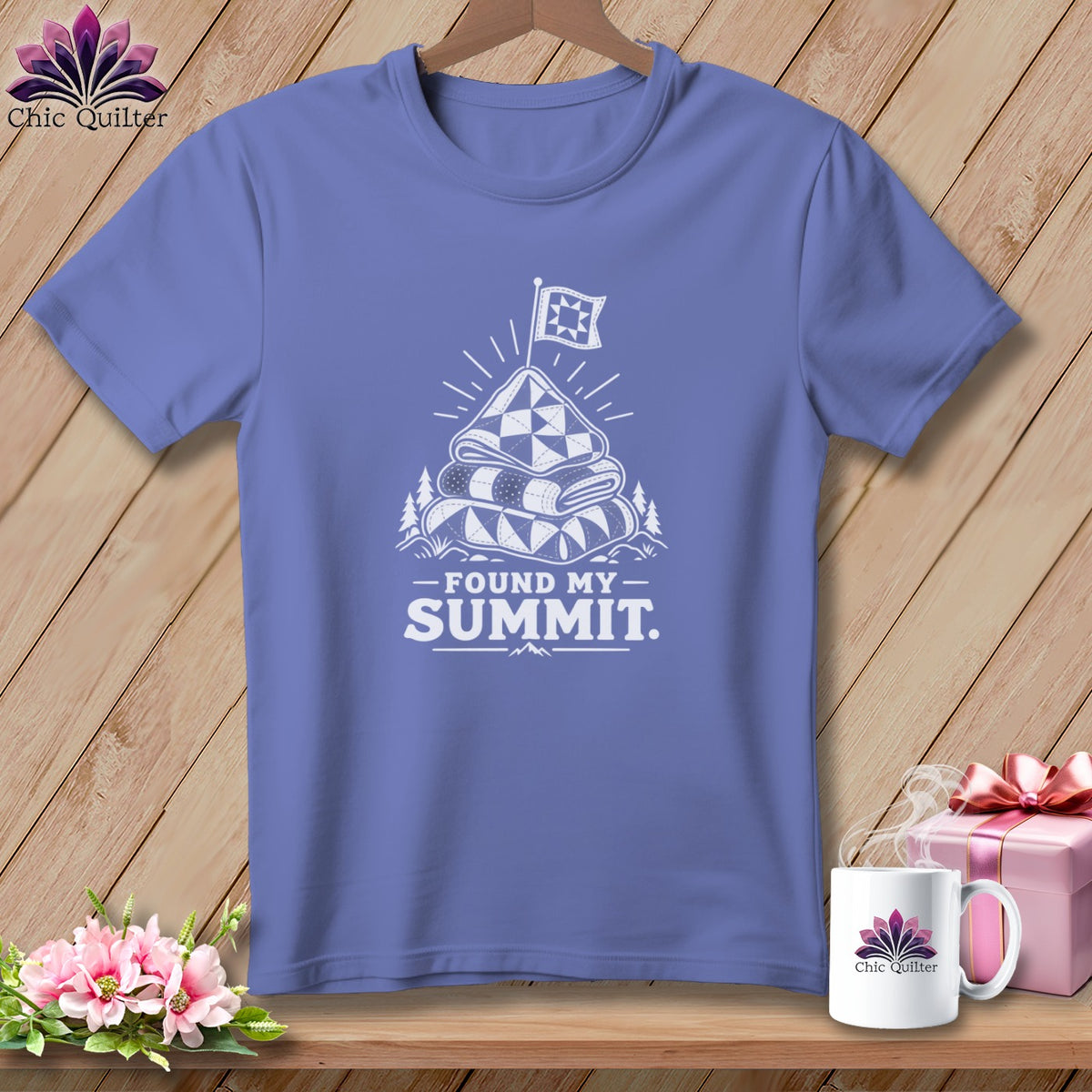 T-shirt with white graphic of stacked quilts and flag, text "Found My Summit".