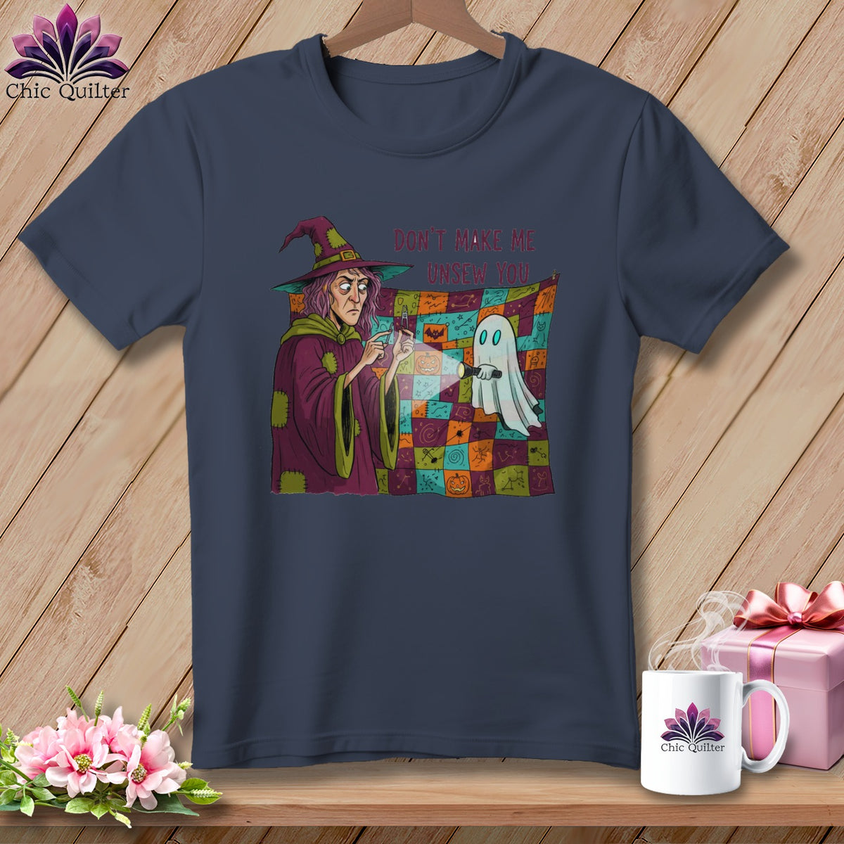 Dark blue t-shirt with a witch and ghost graphic, text reads "Don't Make Me Unsew You."