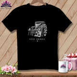 Black t-shirt with illustration of armchair, blanket, and coffee cup. Text reads 