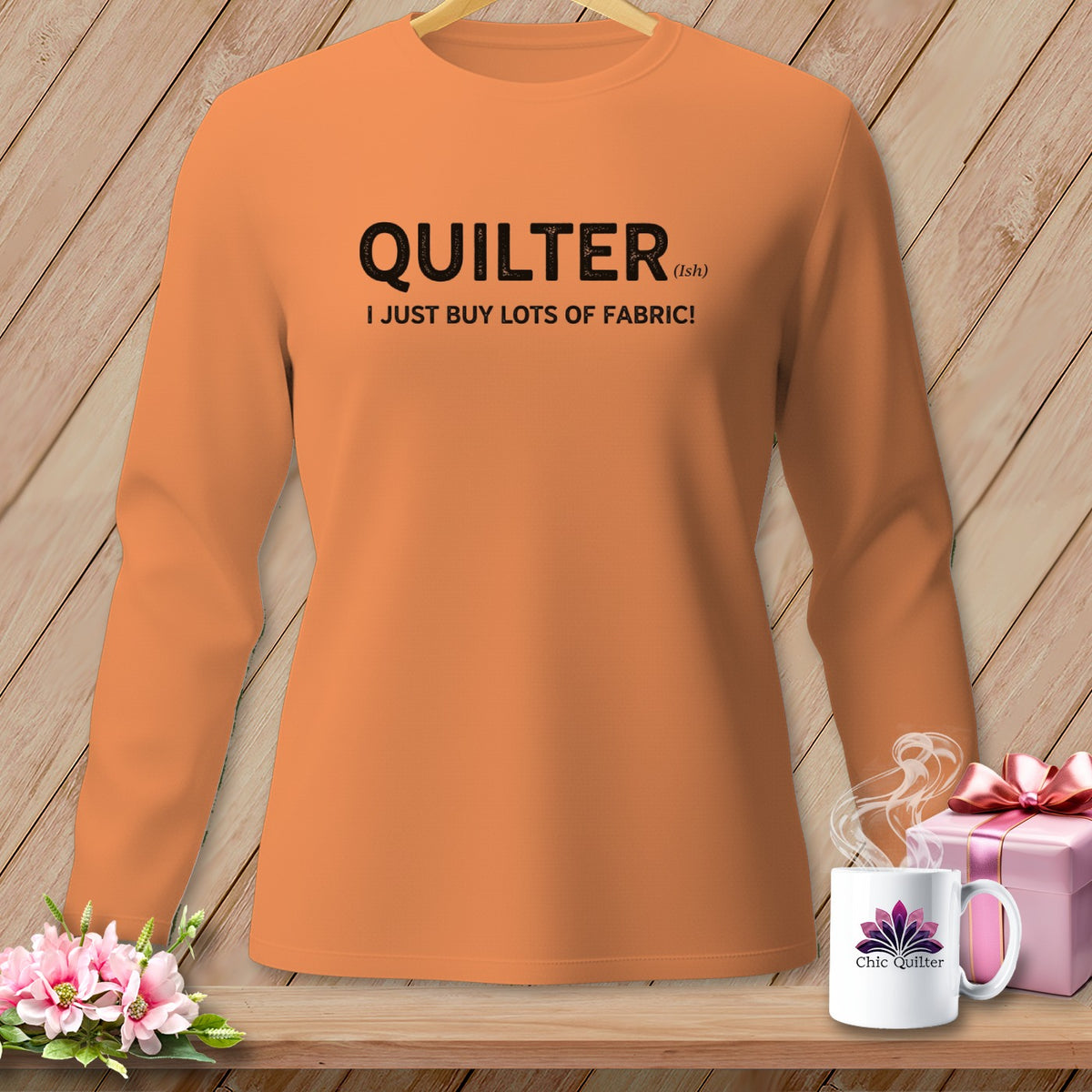 Orange long-sleeve shirt with text "QUILTER (ish). I JUST BUY LOTS OF FABRIC!".