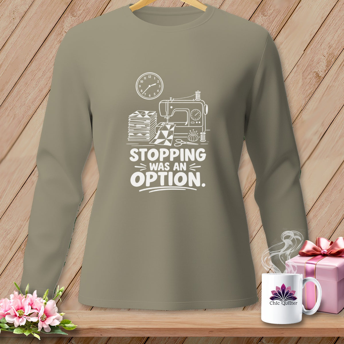 T-shirt with white graphic of sewing machine, fabric, and text "Stopping was an option."