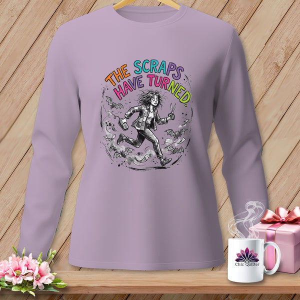 Lilac long-sleeve shirt with "The Scraps Have Turned" graphic and running figure.