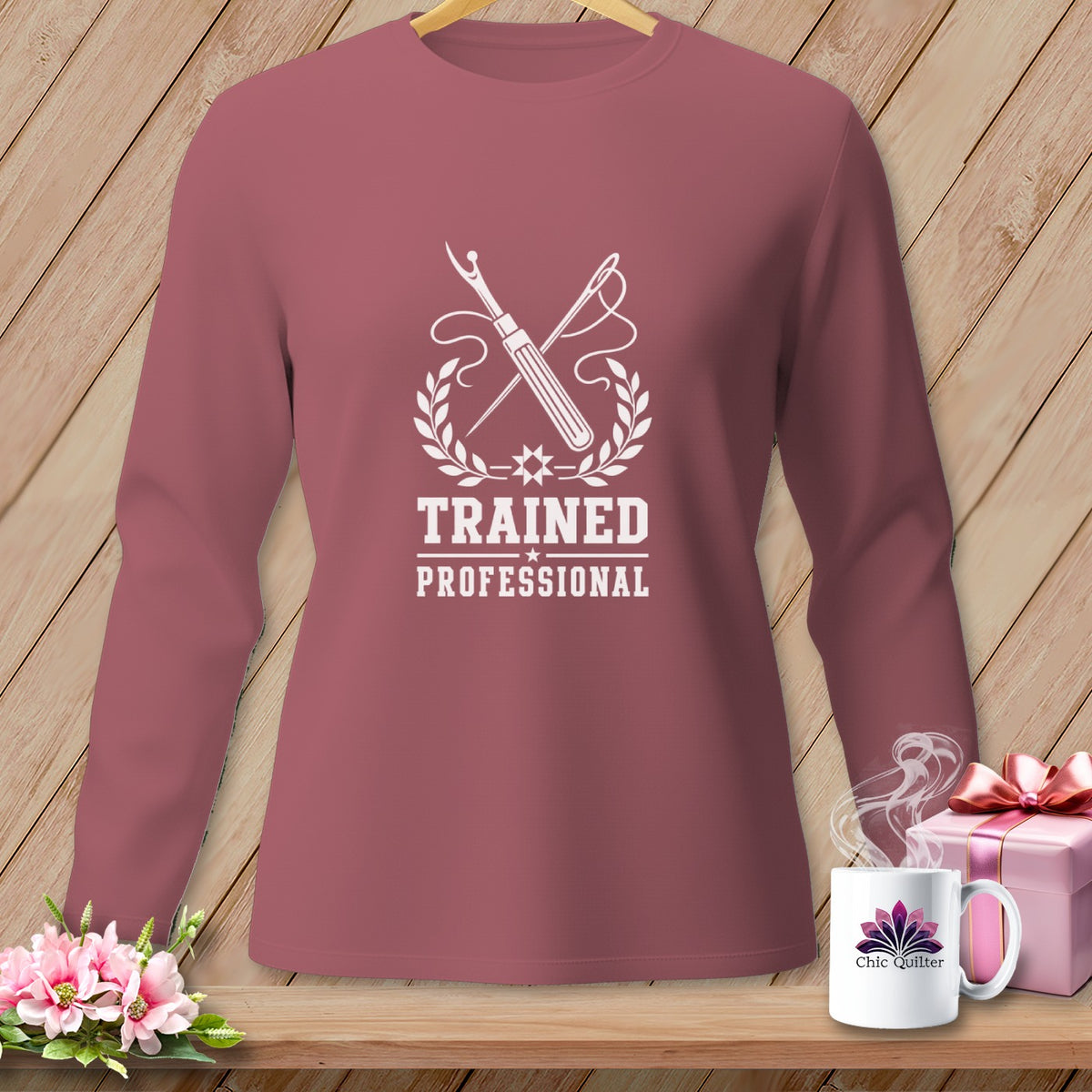 Rose long-sleeve shirt with "Trained Professional" sewing graphic and Chic Quilter mug.
