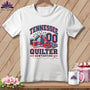 White t-shirt featuring a red, white, and blue Tennessee Quilter graphic with sewing supplies.