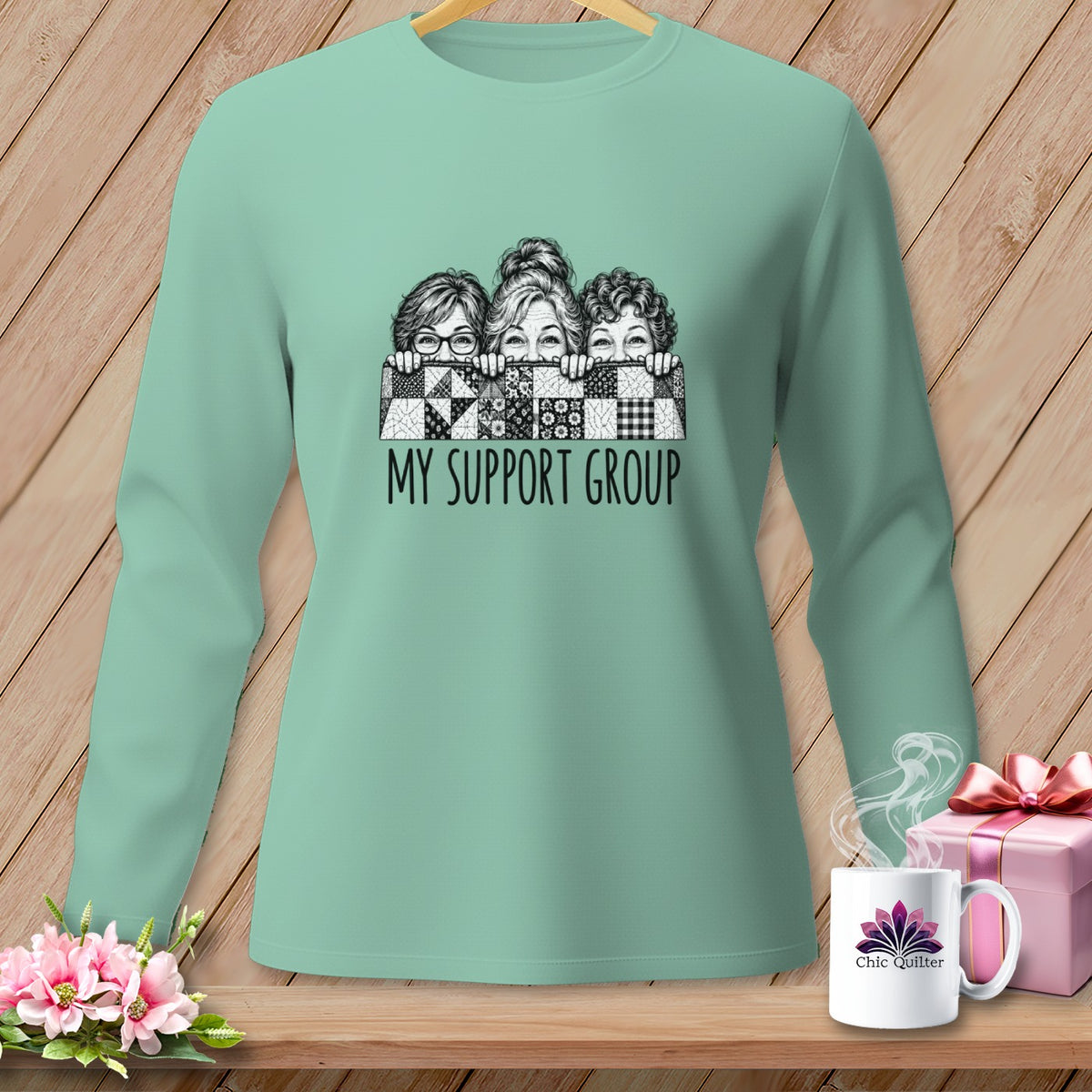 Mint green long-sleeve shirt with three women peeking over a quilt and text "MY SUPPORT GROUP".