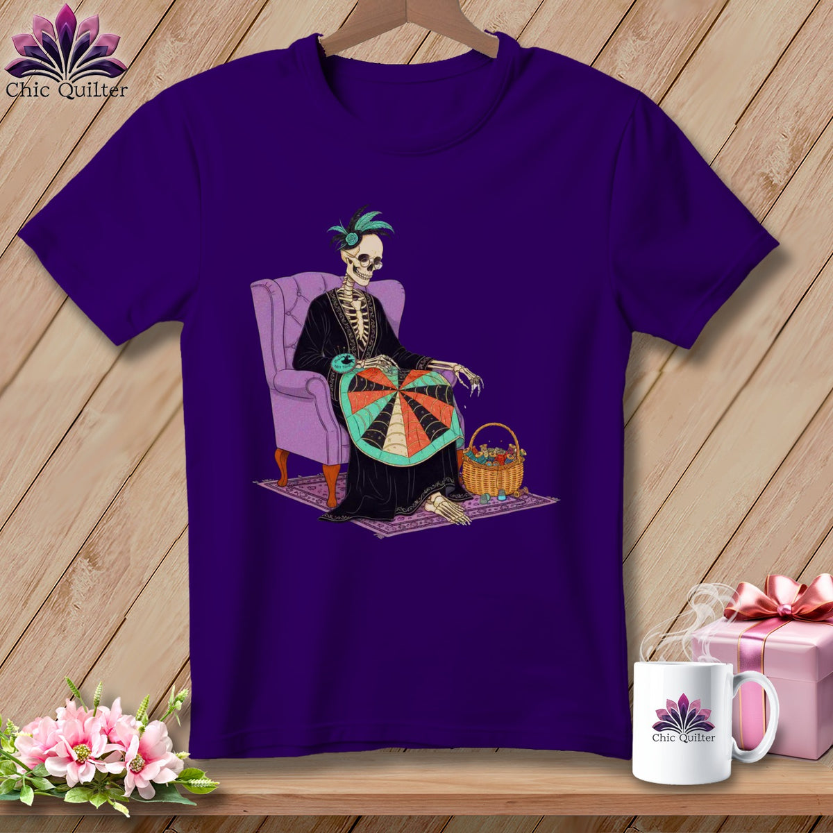 Purple t-shirt featuring skeleton sewing in an armchair with a basket of yarn.