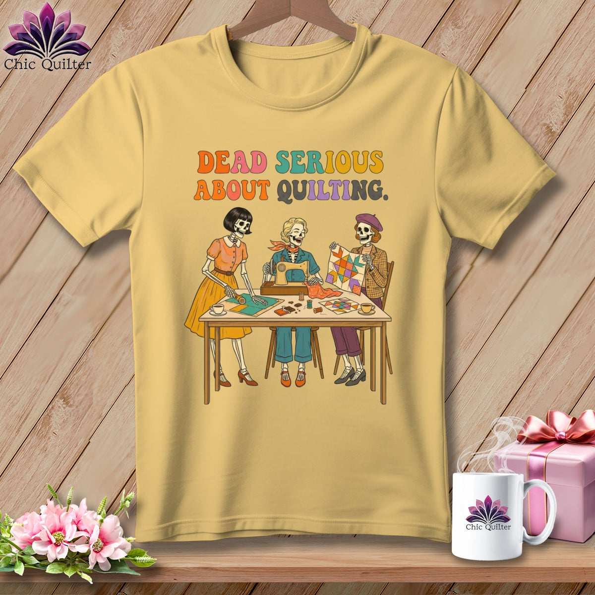 Yellow t-shirt with skeletons sewing and quilting, text "DEAD SERIOUS ABOUT QUILTING."
