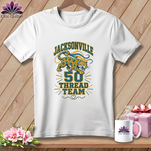 A white t-shirt features a graphic with a leaping jaguar above text reading Jacksonville 50 Thread Team.