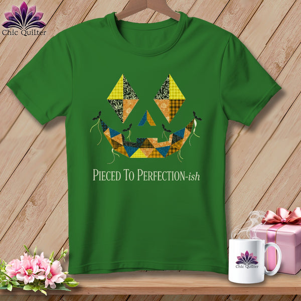 Green t-shirt with a patchwork jack-o'-lantern design and "Pieced To Perfection-ish" text.