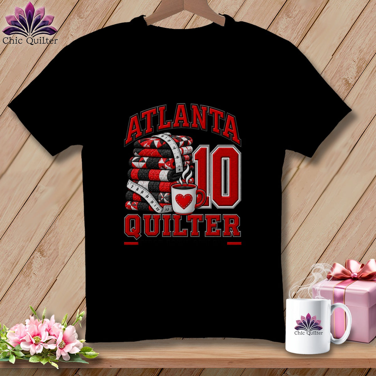 Black t-shirt featuring a red Atlanta Quilter graphic with a stack of quilts, a coffee mug, and the number ten.