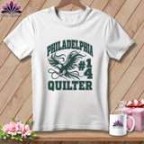 A white t-shirt hanging on a wooden background features a green eagle graphic and the text 