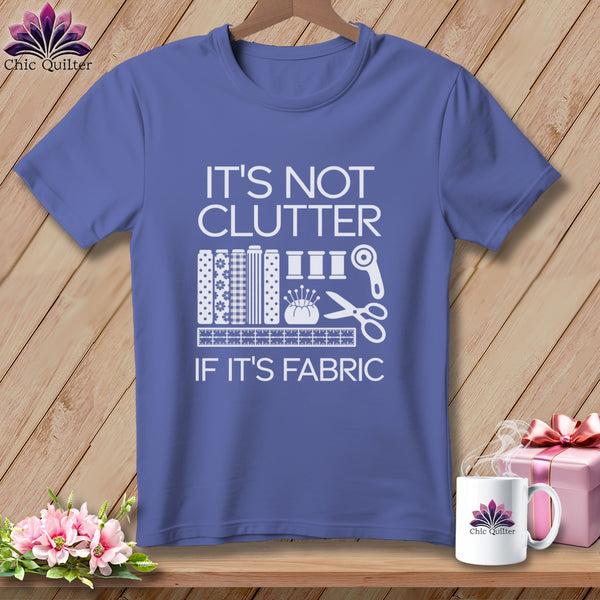 Purple t-shirt with white text "IT'S NOT CLUTTER IF IT'S FABRIC" and sewing graphics.