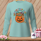 Light blue long-sleeve shirt with a jack-o'-lantern filled with sewing supplies and 