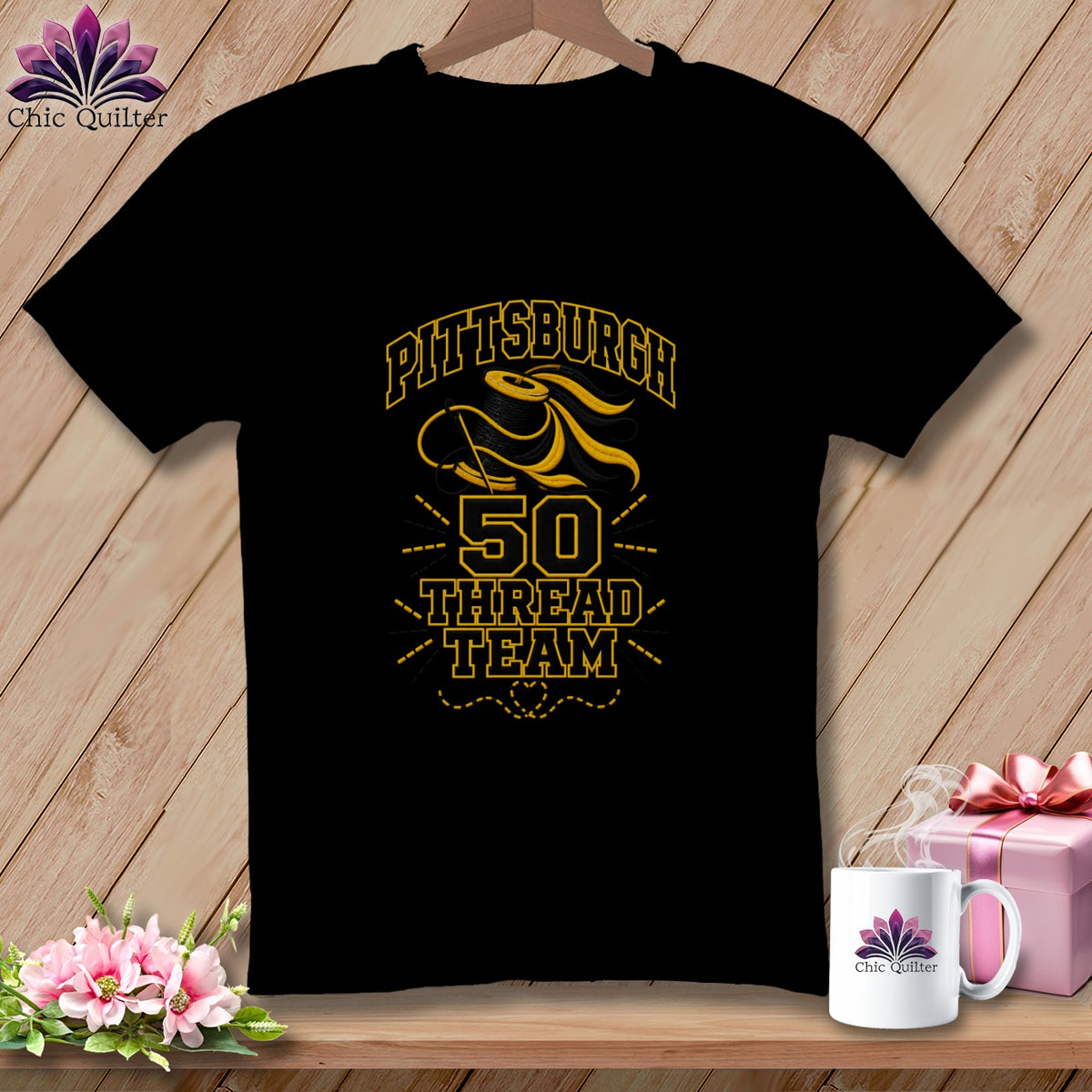 A black short-sleeved t-shirt features yellow graphics with a spool of thread and the text Pittsburgh 50 Thread Team.