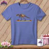 A periwinkle t-shirt featuring an illustration of a dinosaur skeleton with a patchwork quilt body on a wooden background.