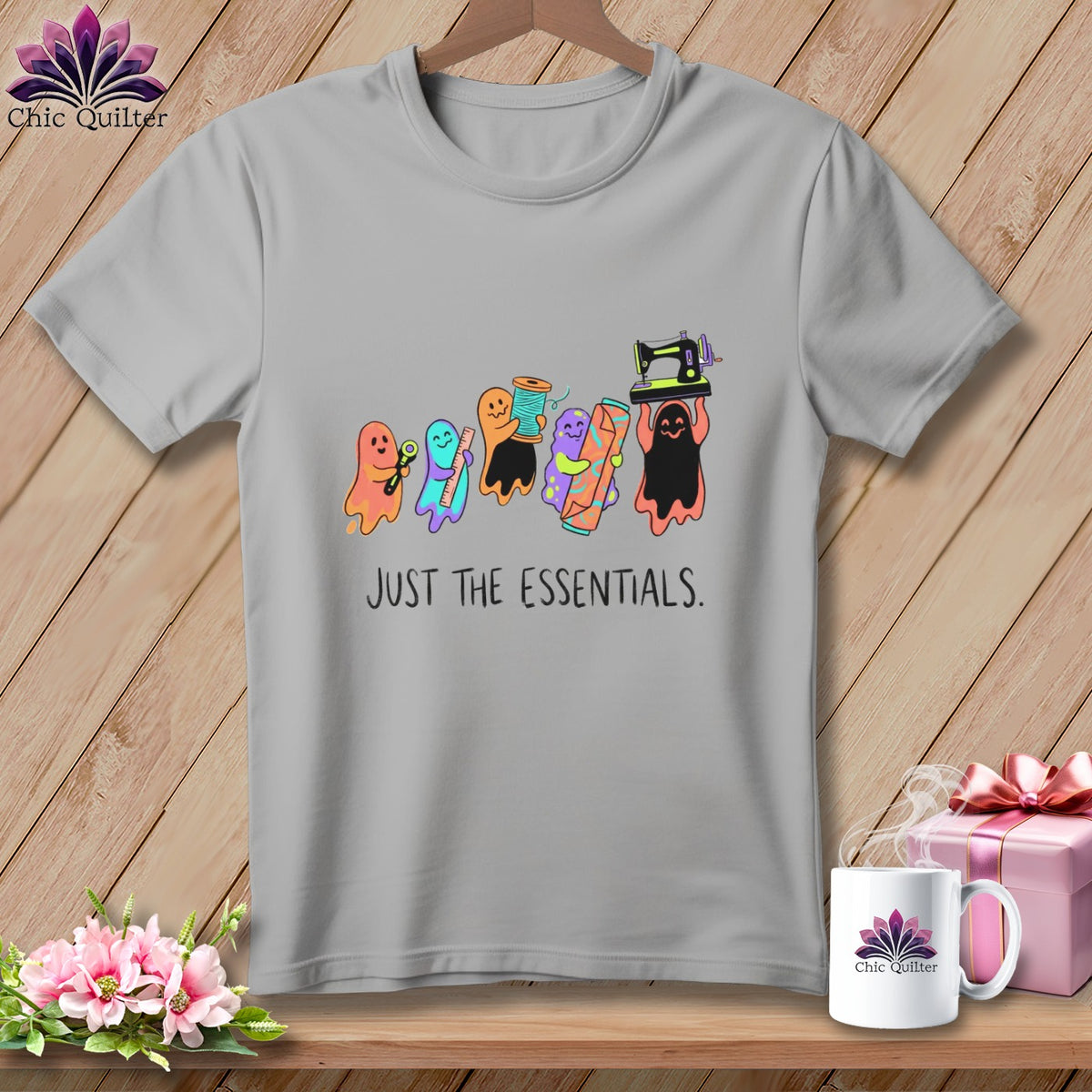 T-shirt with ghosts carrying sewing supplies and the text "JUST THE ESSENTIALS."