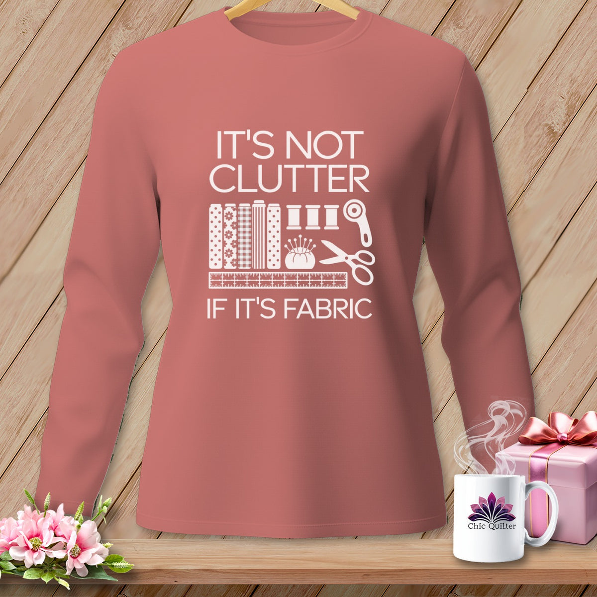Long sleeve shirt with "It's not clutter if it's fabric" graphic.