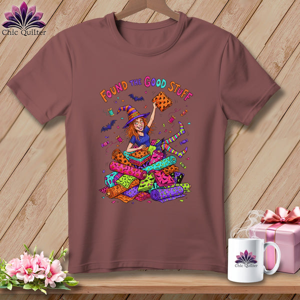 Witch with fabric stash, "Found the good stuff" text, colorful Halloween prints.