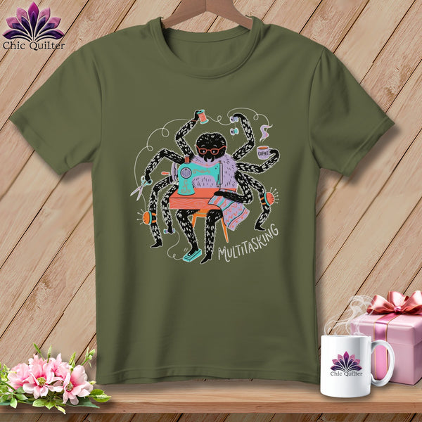 Green t-shirt with a cartoon spider sewing and drinking coffee, text says MULTITASKING.