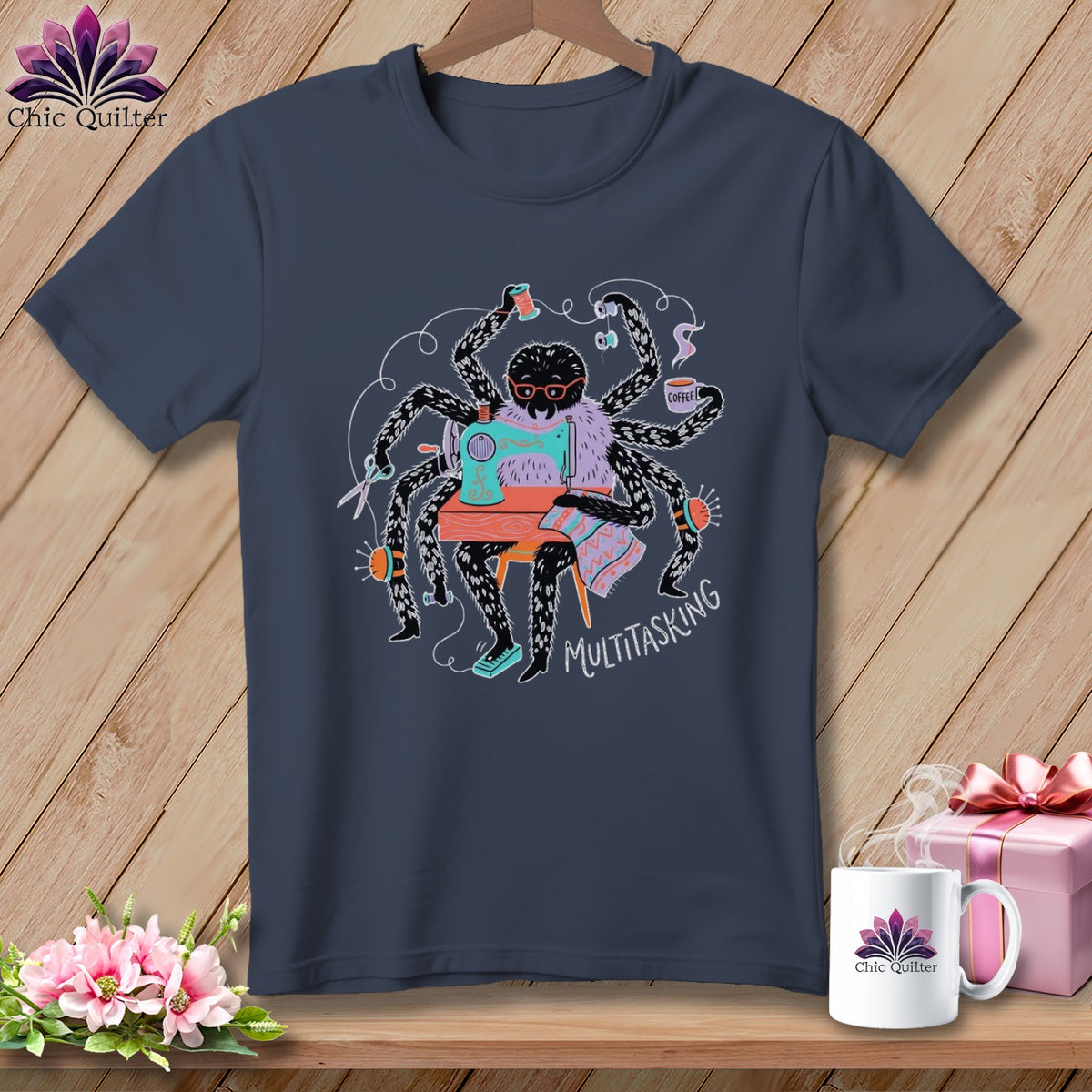 Spider sewing and drinking coffee with "Multitasking" text on a t-shirt.