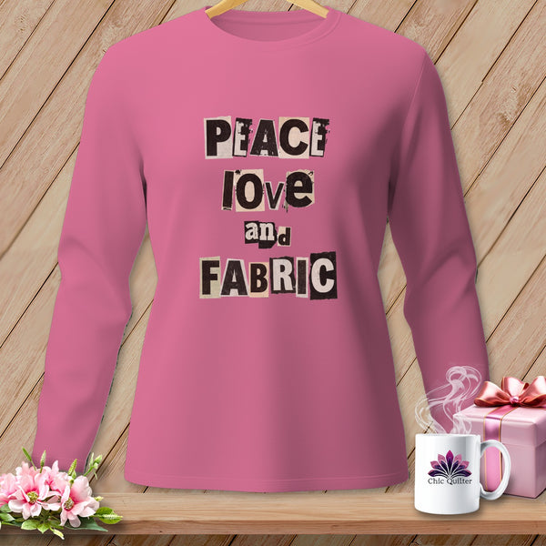 Pink long-sleeve shirt with "PEACE love and FABRIC" text in cutout letters.