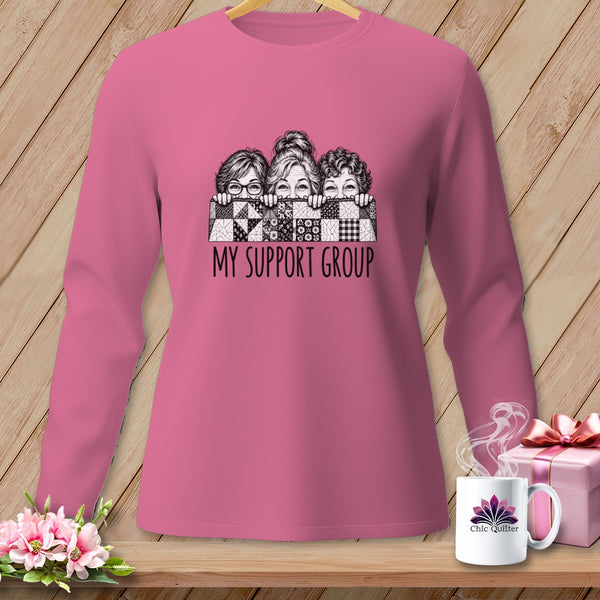 Pink long-sleeve shirt with "My Support Group" text and sketched women behind a quilt.