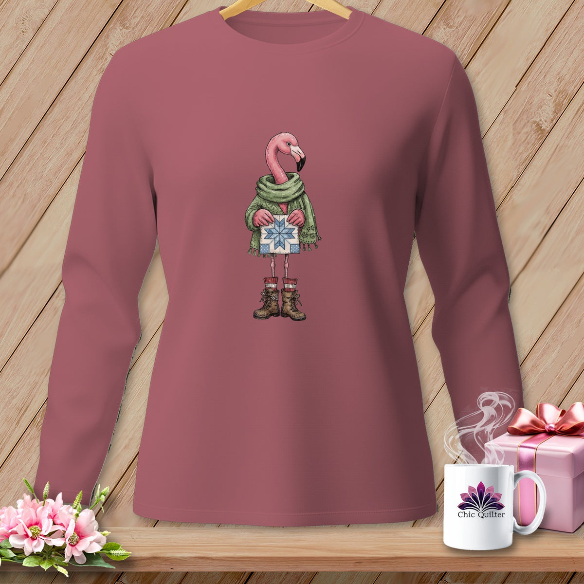 Long-sleeved shirt with a cartoon flamingo holding a gift.