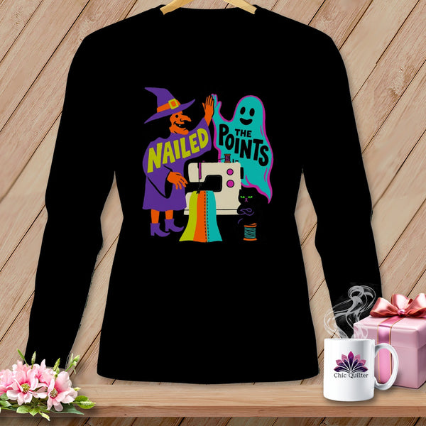 Black long-sleeve shirt with witch, ghost, and sewing machine Halloween graphic.