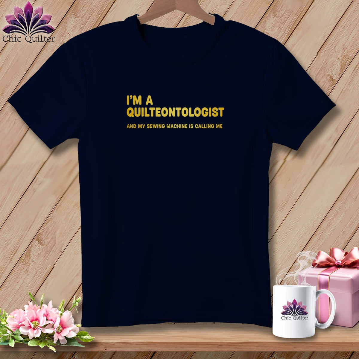 Navy t-shirt with yellow text reading "I'M A QUILTEONTOLOGIST AND MY SEWING MACHINE IS CALLING ME."