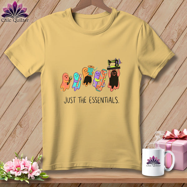 Yellow t-shirt with ghosts holding sewing supplies and text "JUST THE ESSENTIALS."