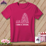 Pink t-shirt with a stack of folded fabric and chaotic fabric scraps, text 