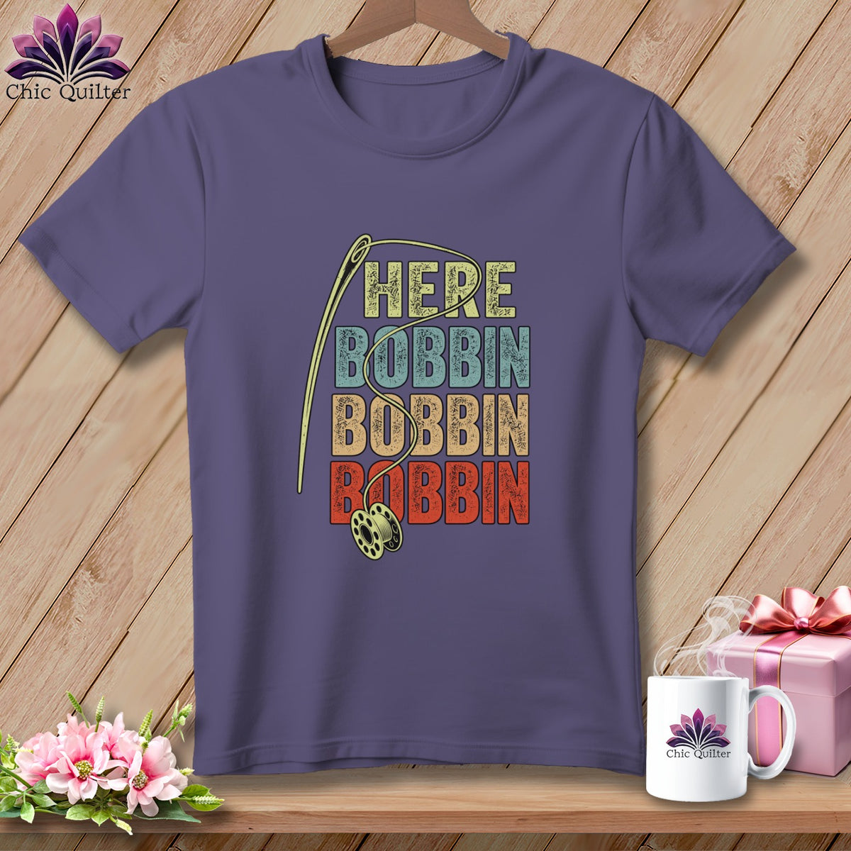 Purple t-shirt with needle, bobbin, and text "HERE BOBBIN BOBBIN BOBBIN".