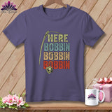 Purple t-shirt with needle, bobbin, and text 