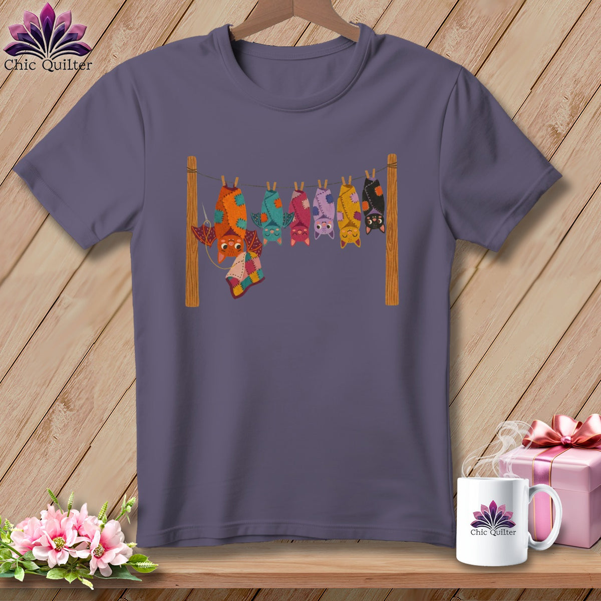 T-shirt with a graphic of colorful bats hanging on a clothesline.