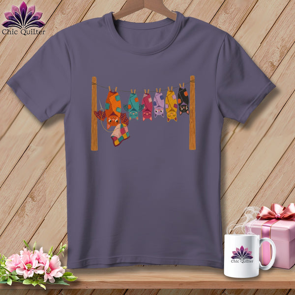 T-shirt with a graphic of colorful bats hanging on a clothesline.