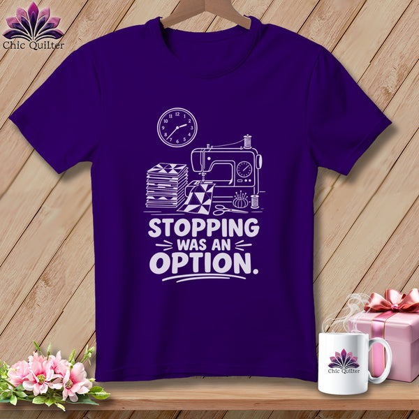 Purple t-shirt with sewing machine, fabric, and "Stopping was an option" text.