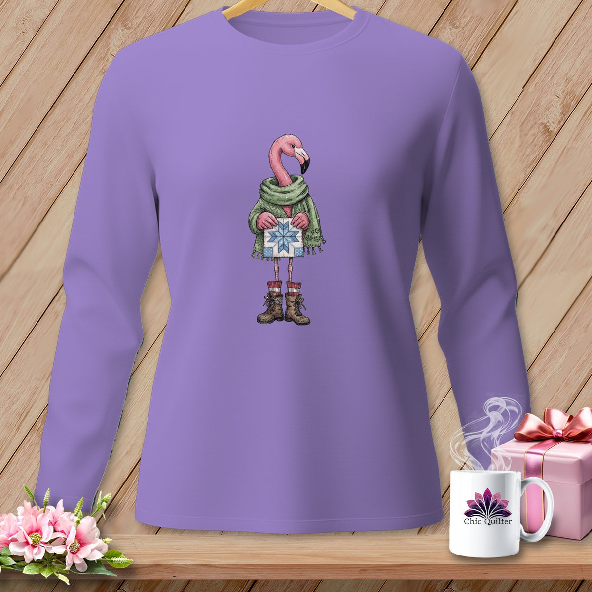 Purple long-sleeve shirt with a flamingo illustration holding a gift.