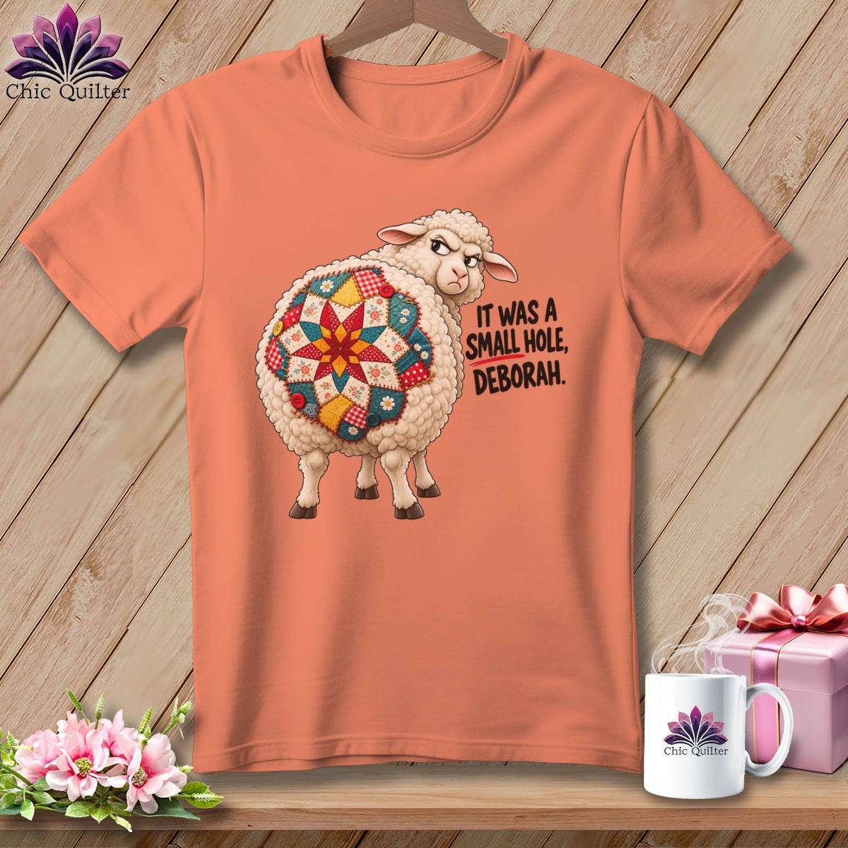 Orange t-shirt with a sheep graphic saying "It was a small hole, Deborah."