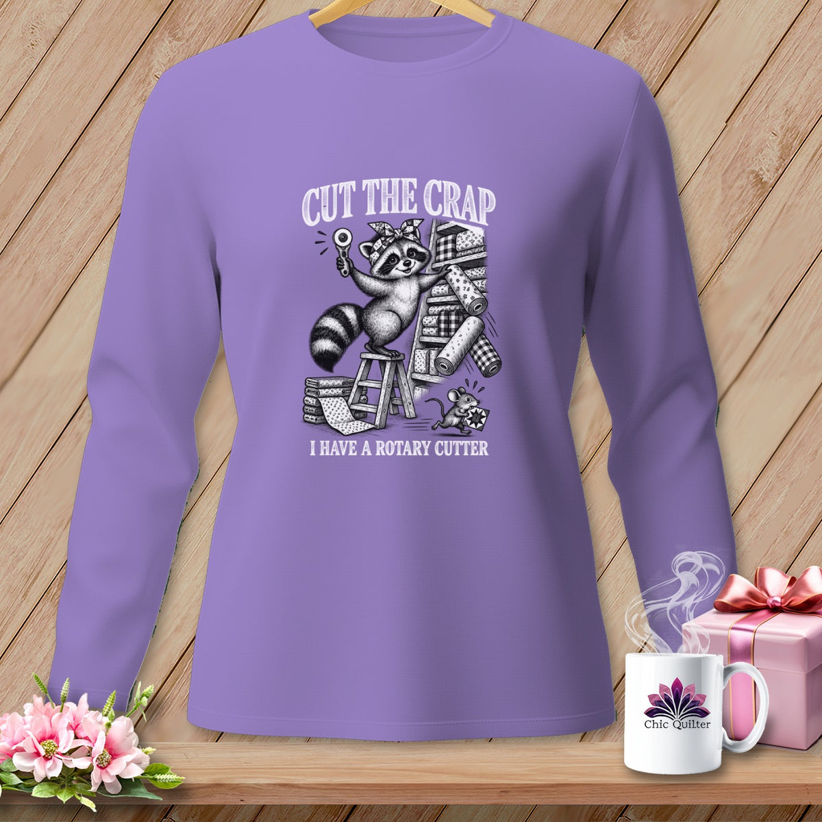 Purple long-sleeve shirt with raccoon holding rotary cutter, "Cut the Crap" text.