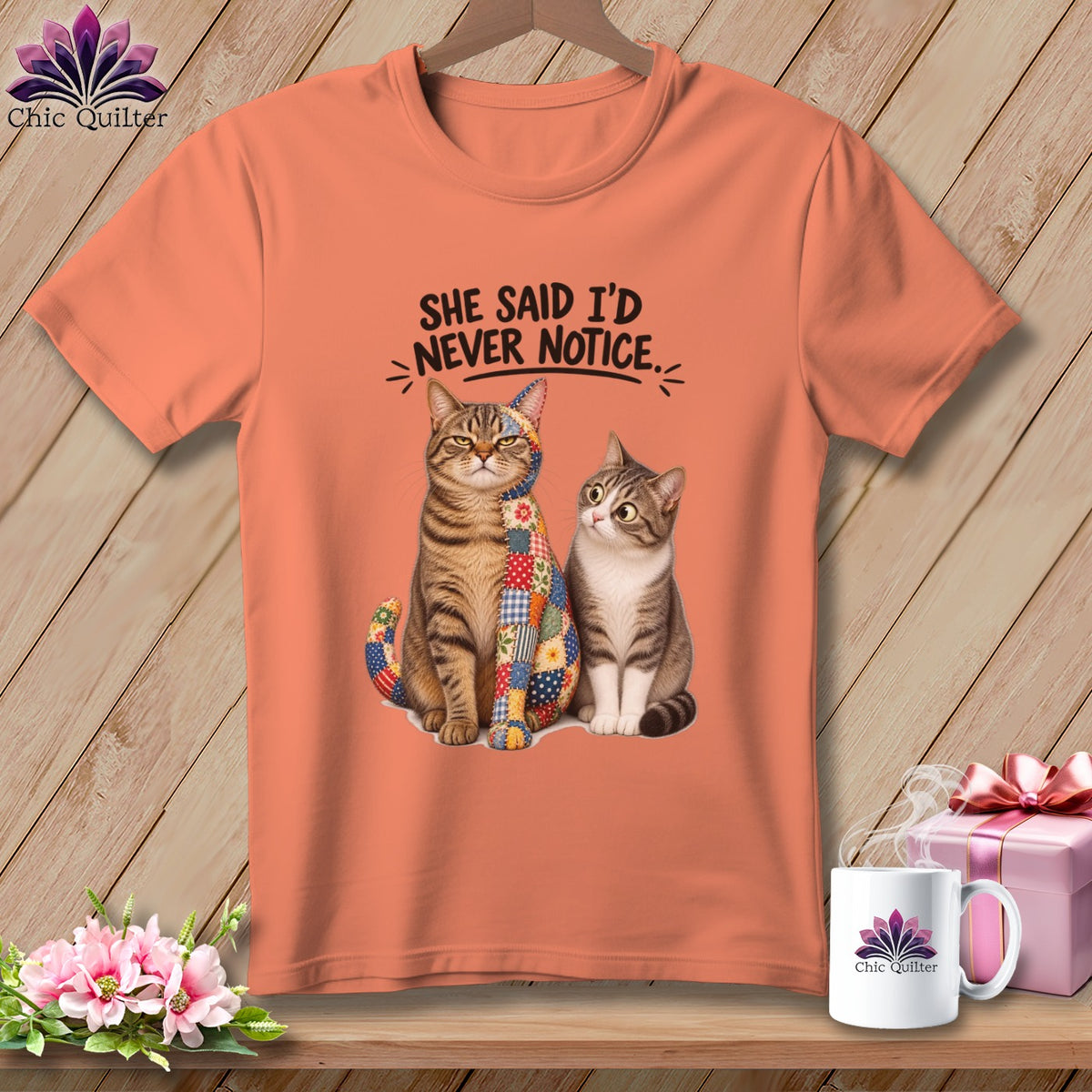 Peach t-shirt with two cats, one with a patchwork design and text "SHE SAID I'D NEVER NOTICE."