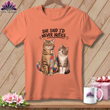 Peach t-shirt with two cats, one with a patchwork design and text 