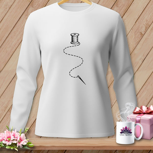 White long-sleeved shirt with a spool of thread and needle graphic.