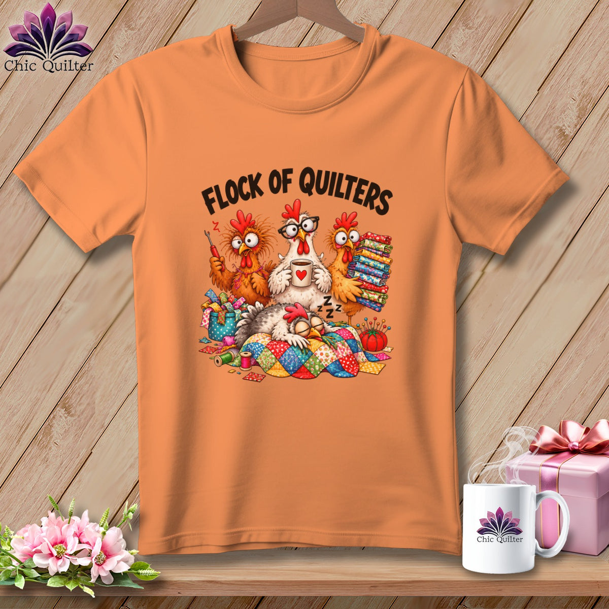 Orange crewneck t-shirt featuring a cartoon illustration of cartoon chickens and the text "Flock of Quilters".