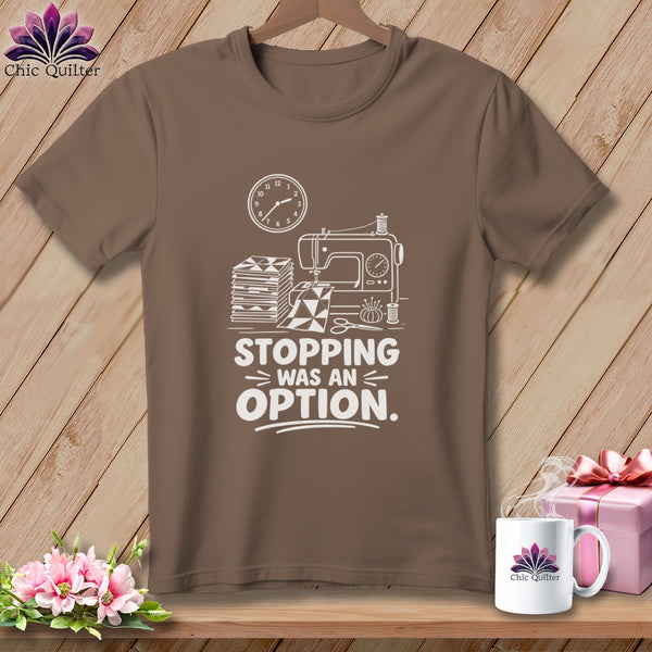 Brown t-shirt with sewing machine, fabric, and clock graphic and "Stopping was an option" text.
