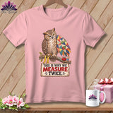 Pink t-shirt with an owl wearing glasses and holding a patchwork wing, with text.