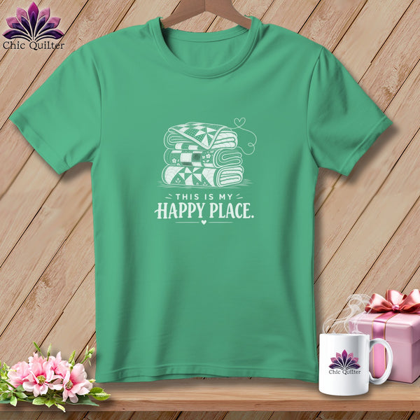 Green t-shirt with stacked folded quilts and "This is my happy place" text.