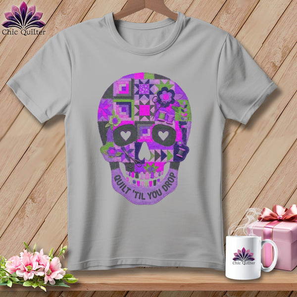 Gray t-shirt with purple patchwork skull design and text.