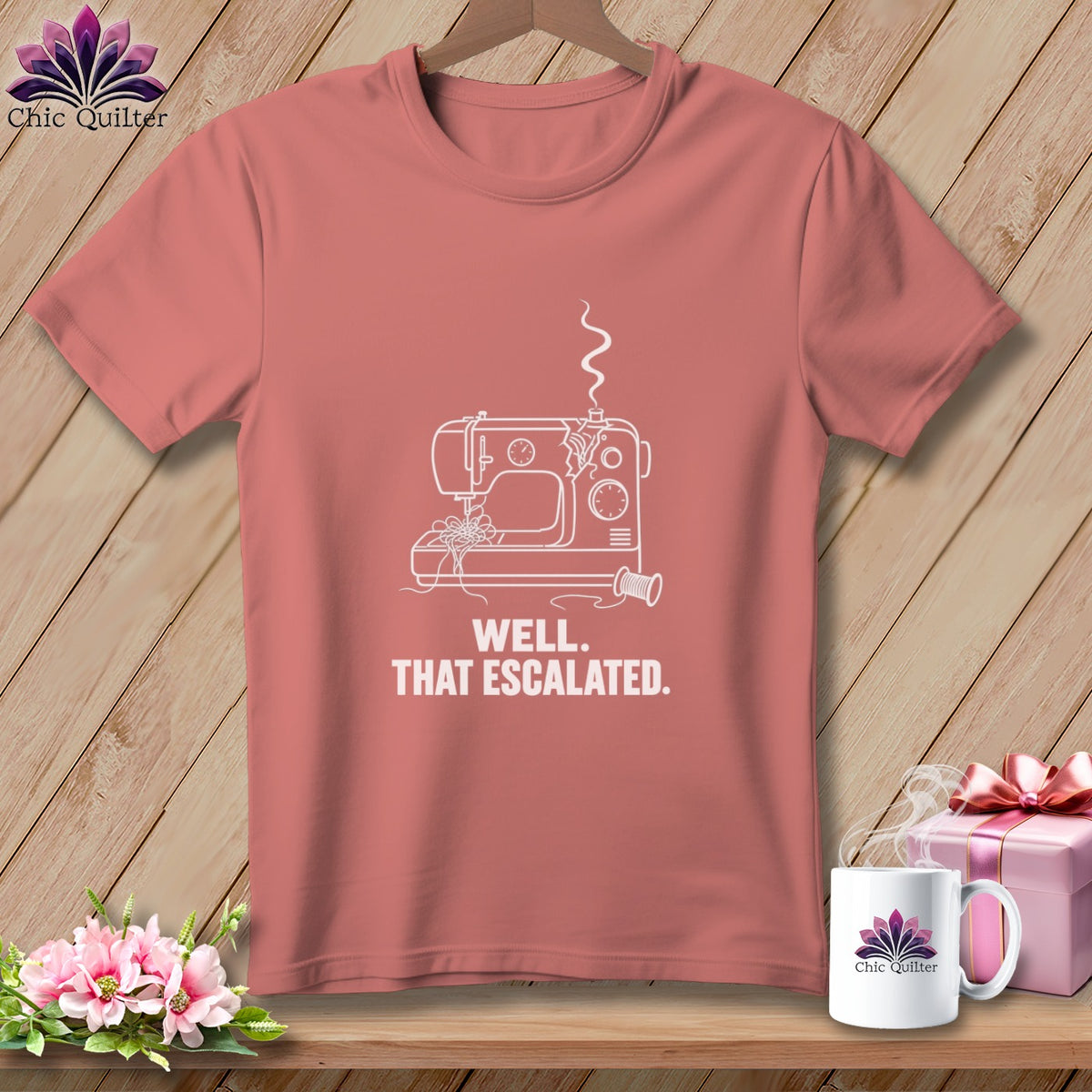Coral t-shirt with white line art of a sewing machine and text "WELL. THAT ESCALATED."