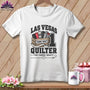 A white crewneck t-shirt featuring a quilting graphic with Las Vegas Quilter text, hanging on a wooden background.